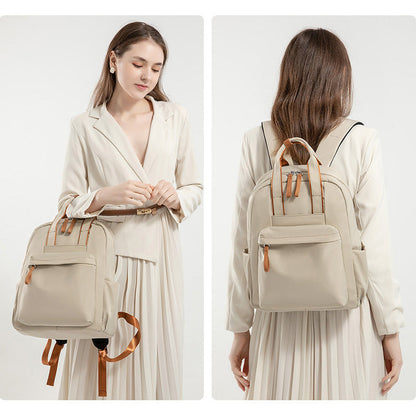 Woman holding and wearing a beige backpack with brown straps on a white background